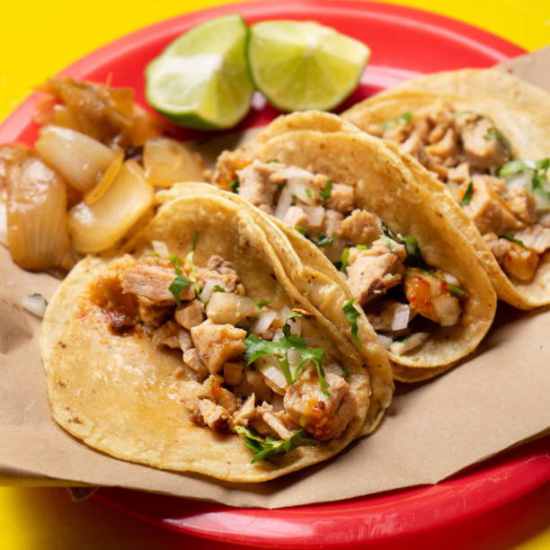 Mexican beef tacos also called "sink" on yellow background stock photo