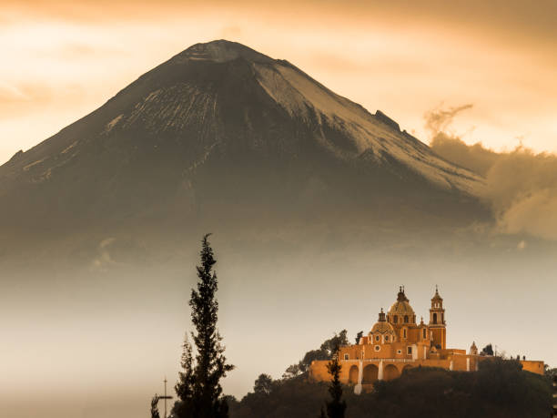 Mexican church in front of the Popocatepetl volcano stock photo