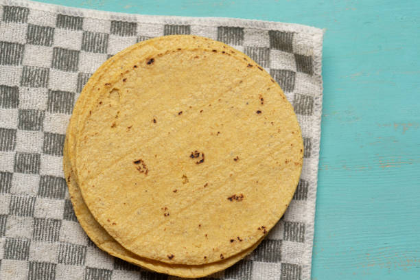 Mexican corn tortillas on turquoise background stock photo