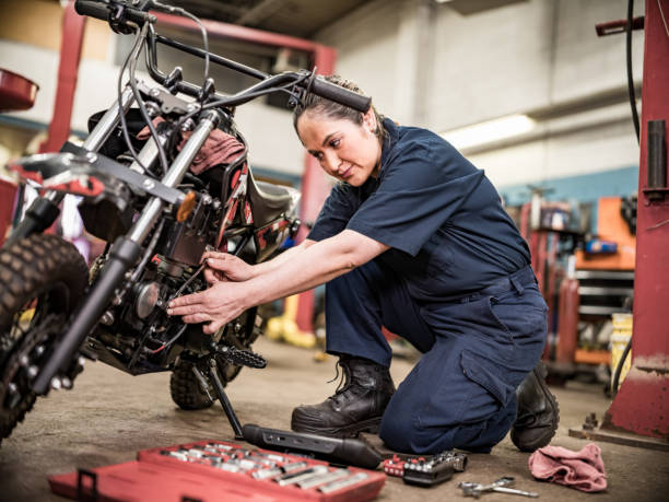 Mexican female mechanic in her shop stock photo