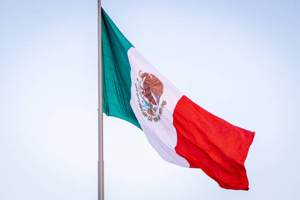 Mexican flag waving in the air stock photo