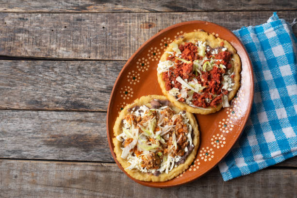 Mexican food: sopes of Chorizo and beef picadillo with cheese and beans stock photo