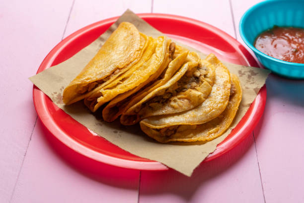 Mexican food: Tasty basket tacos "canasta" on colorful  background stock photo