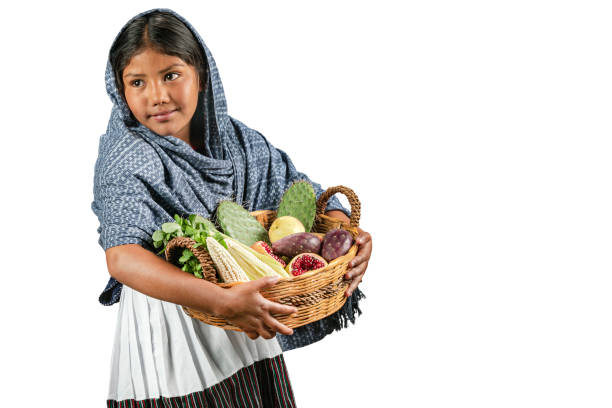Mexican girl selling variety of natural foods in a basket. Beautiful girl offering her recent harvested vegetables pretty mexican girls stock pictures, royalty-free photos & images