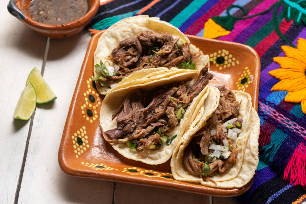 Mexican slow cooked lamb tacos also called barbacoa on white background stock photo