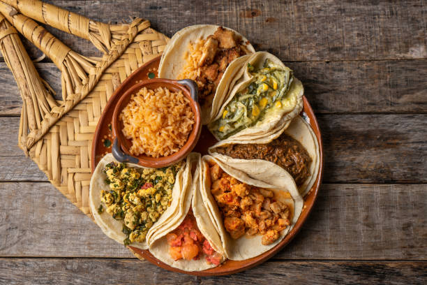 Mexican stew tacos also called "stews" with rice on wooden background stock photo
