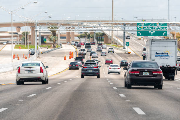Miami cars driving on Palmetto Expressway highway street road with overpass bridges for exits in Florida stock photo