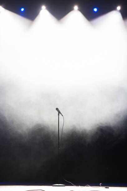 Microphone against smoky disco concert background. Live music background. stock photo