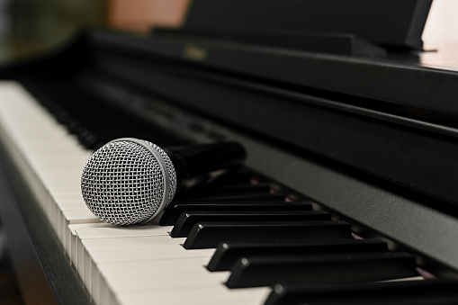 microphone for singing on the keys of an electronic digital piano. close-up.