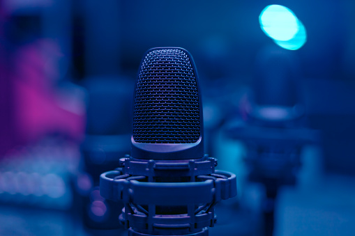 Microphone in blue room . Low light in broadcasting studio