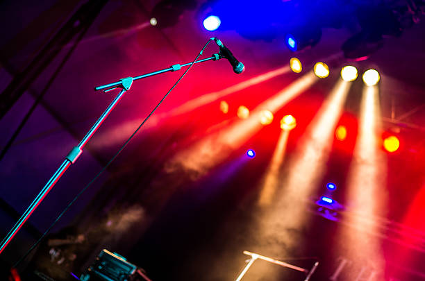 microphone micro concert yellow red lights bokeh horizontal Microphone in a concert musical theater stock pictures, royalty-free photos & images