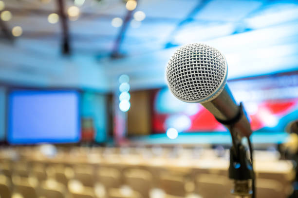 Microphone stand abstract blurred photo in conference hall stock photo