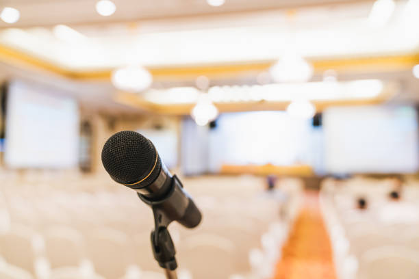 Microphone stand in conference hall. Public announcement event, Organization company meeting, or graduation award ceremony concept Microphone stand in conference hall. Public announcement event, Organization company meeting, or graduation award ceremony concept presentation speech photos stock pictures, royalty-free photos & images