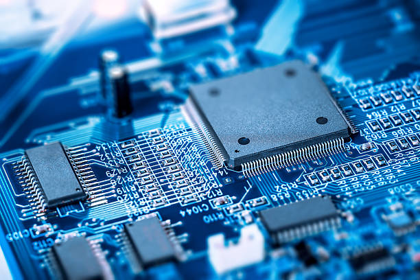 Microprocessor on blue circuit board Electronic blue Circuit Board. Focus on main large chip.  semiconductor stock pictures, royalty-free photos & images