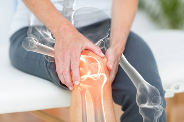 Mid section of man suffering with knee pain stock photo