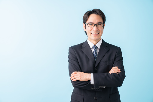 Asian middle age businessman, blue background