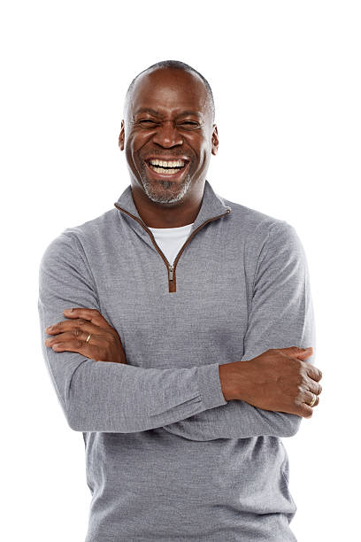 Middle aged african man laughing on white stock photo