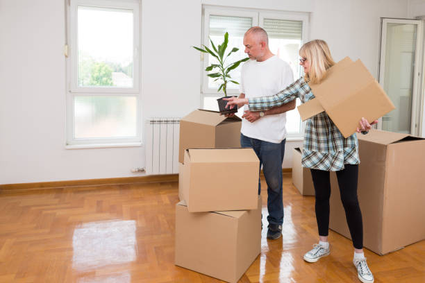 Middle aged couple moving into new apartment. stock photo