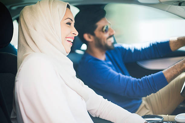Middle eastern couple driving a luxury car in Dubai One beautiful couple driving a car. middle eastern culture stock pictures, royalty-free photos & images