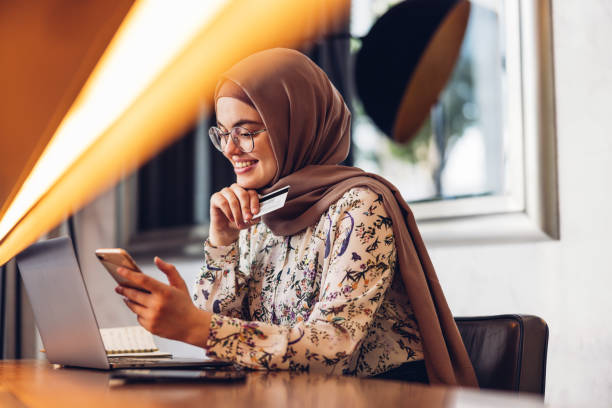 Middle Eastern Girl Shopping Online Using Credit Card stock photo