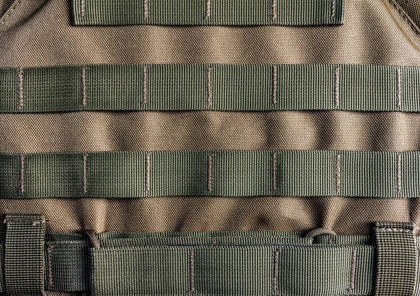 Military armor vest molle system. Photo of a military armor vest molle system closeup view. armored clothing stock pictures, royalty-free photos & images