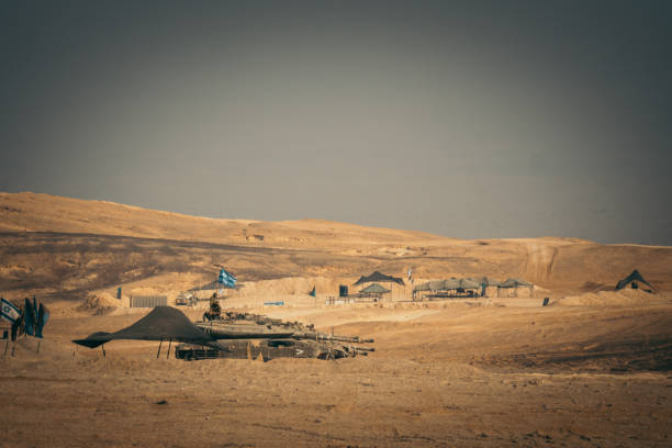 Military camp on the desert. Paintball Old tanks and tents standing on a sand military base stock pictures, royalty-free photos & images