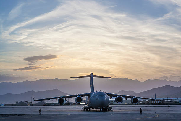 C-17 Military Cargo Transport Aircraft Kabul, Afghanistan - May 07, 2016: US Air Force C-17 Military Cargo Transport Aircraft on the taxiway at sunset. us air force stock pictures, royalty-free photos & images