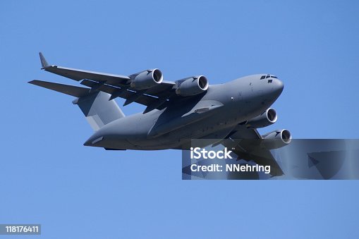 istock military jet cargo airplane C17 Globemaster flying in blue sky 118176411