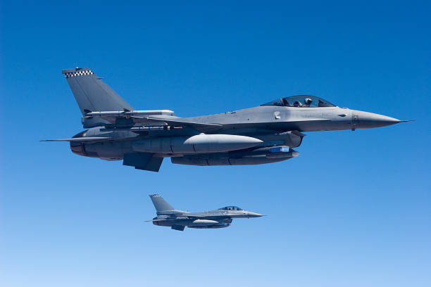 Military Jets in Flight Two F-16's in formation. air force stock pictures, royalty-free photos & images