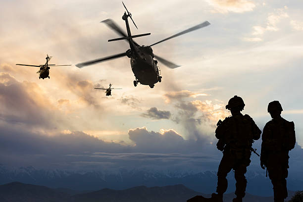 Military Mission 
Military helicopters leave behind soldiers for a  mission at dusk. military helicopter stock pictures, royalty-free photos & images