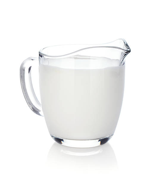 Milk jug Milk jug. Isolated on white background cream dairy product stock pictures, royalty-free photos & images