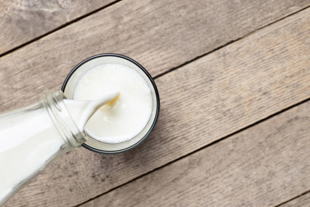 melk gieten in glas - melk stockfoto's en -beelden