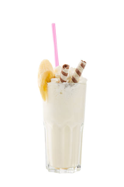Milkshake with waffle, banan, straw isolated white stock photo