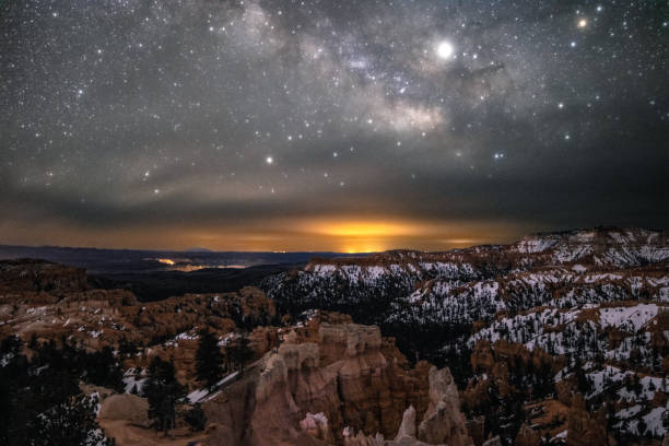 Milky Way in the night sky over a snow covered desert landscape. Bryce Canyon National Park's hoodoos and rock formations. bryce canyon stock pictures, royalty-free photos & images