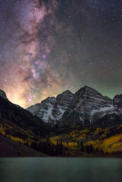 Milky Way over Maroon Bells, Aspen, Colorado Bright and beautiful milky way over Maroon Bells, Colorado. Amazing reflection of the milky way on Maroon lake during Fall color. aspen colorado stock pictures, royalty-free photos & images