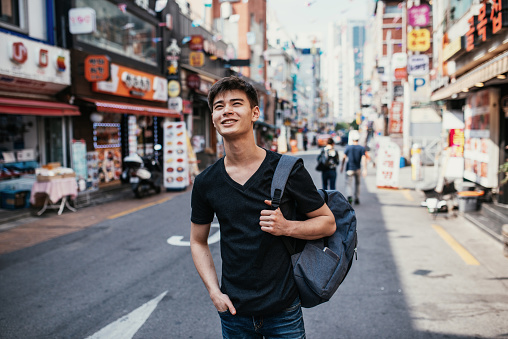 South Korean youth lifestyle in the capital city. Mixed race young millennial man half Korean, half Russian living and studying in Seoul.
