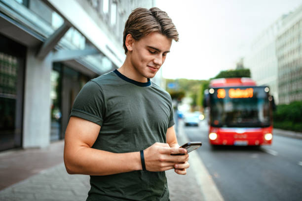 Millennial Scandinavian using phone for ridesharing Millennial Scandinavian using phone oslo stock pictures, royalty-free photos & images