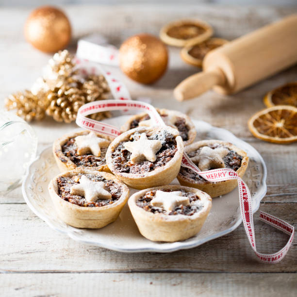 Mince pies on white plate Homemade festive mince pies on white plate tart dessert photos stock pictures, royalty-free photos & images