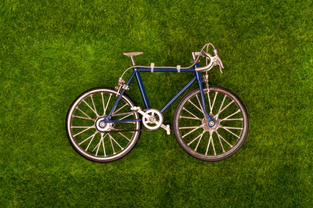 Mini retro blue toy bike on the grass meadow stock photo