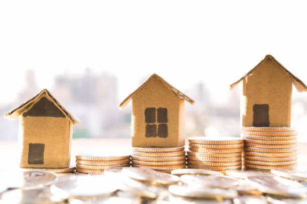 Miniature house model and Financial statement with coins. Finance and house loan, saving money for a house or material design  concepts. stock photo