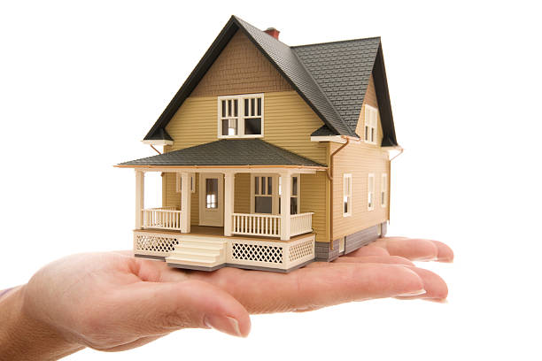Miniature Model house sitting on female hands Miniature Model house sitting on female hands Miniature model concept house resting on a female hand single family rental stock pictures, royalty-free photos & images