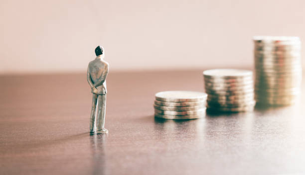 Miniature people looking future with stack coin about financial and money savings concept. stock photo