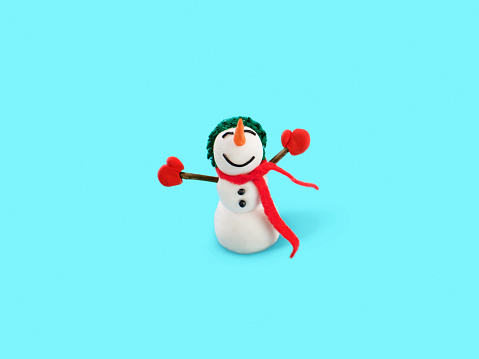 Miniature Snowman on a blue background Trendy minimal concept of holidays
