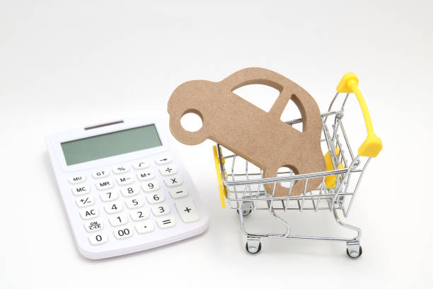 Miniature wooden car, shopping cart and calculator on white background. Concept of buying new car. Miniature wooden car, shopping cart and calculator on white background. Concept of buying new car. car insurance quotes stock pictures, royalty-free photos & images