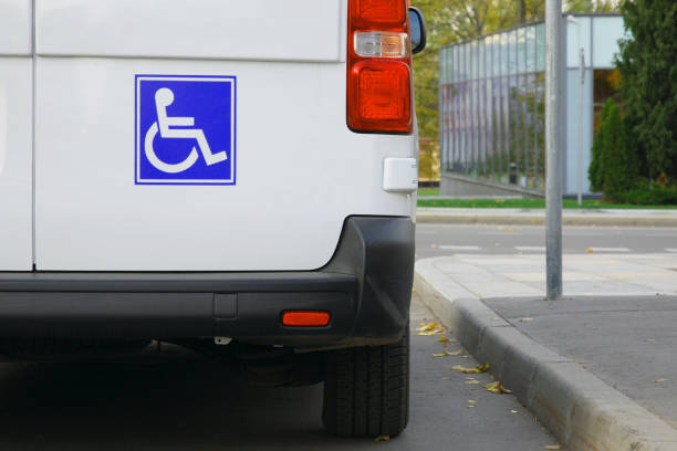 Minibus for disabled passengers, disability sign close up Minibus for disabled passengers with disability icons or signs on it ISA stock pictures, royalty-free photos & images