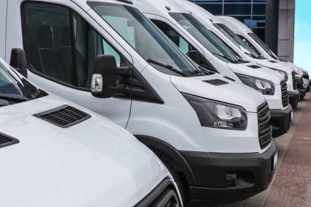 minibuses and vans outside number of new white minibuses and vans outside commercial land vehicle stock pictures, royalty-free photos & images