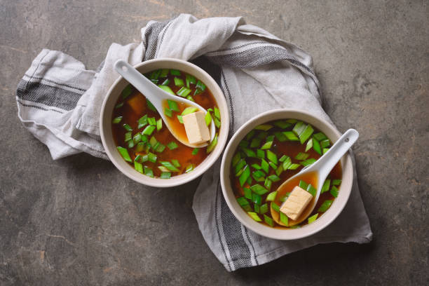 Miso soup Traditional miso soup in two bowls, simply cooked tofu and miso sauce dish, rich source of vegan protein, view from directly above algae photos stock pictures, royalty-free photos & images
