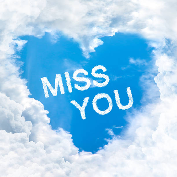 miss you word on blue sky stock photo