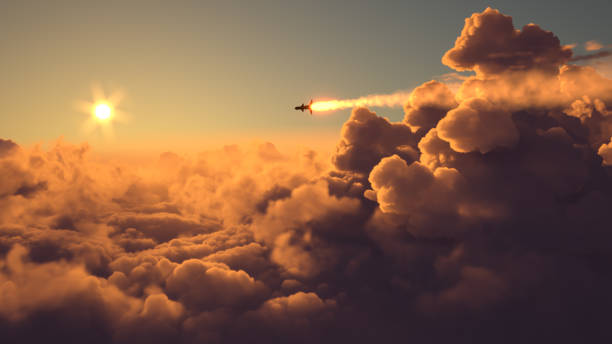 Missile fly above the clouds at sunset stock photo