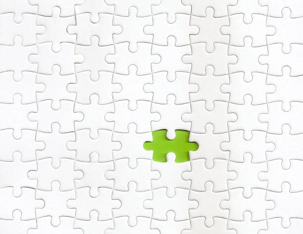 Missing piece of puzzle with a green color as background Missing piece of puzzle with a green color as background incomplete stock pictures, royalty-free photos & images